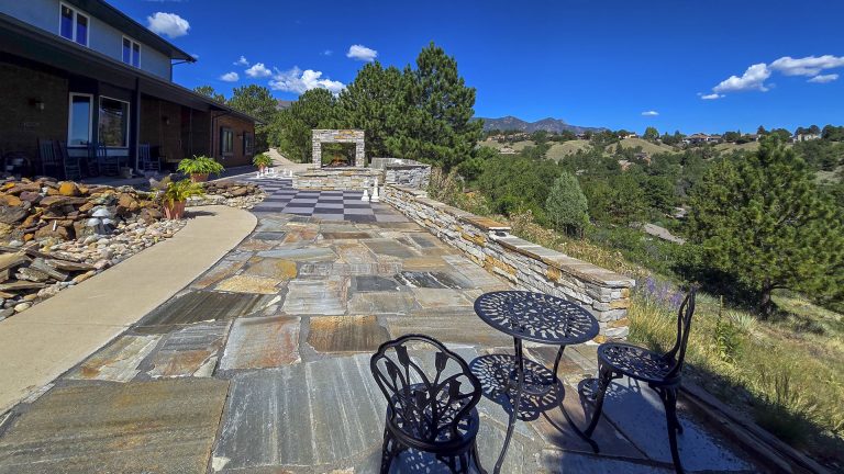 Flagstone patio with seating area overlooking mountains and desert landscape